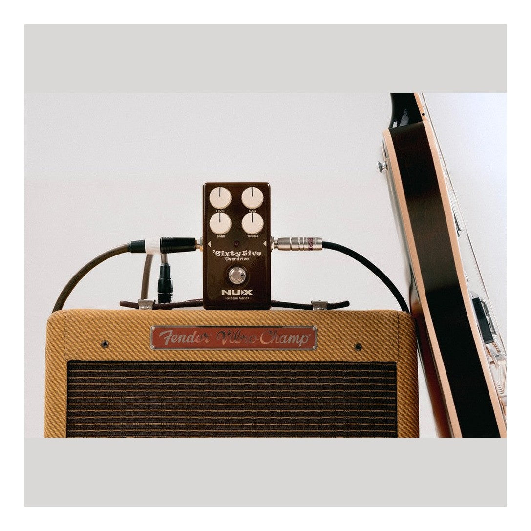 NUX 6ixty 5ive Overdrive Pedal Lifestyle Shot With Guitar and Amp