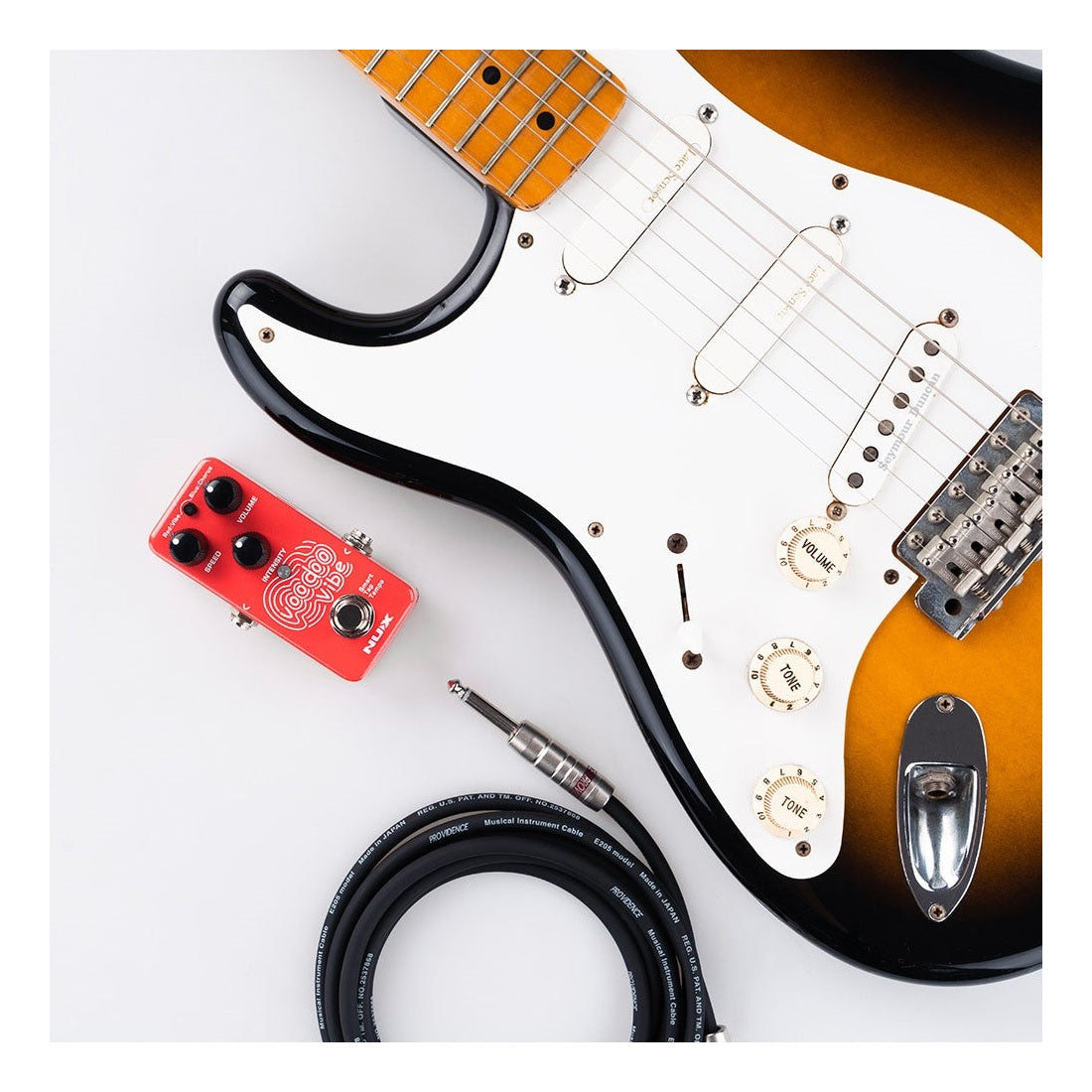 NUX Voodoo Vibe Lifestyle Shot with Guitar and Cable