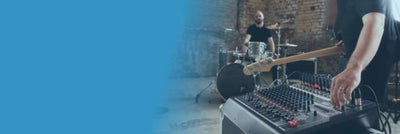 Person operating a mixing console with a blue overlay on the left side