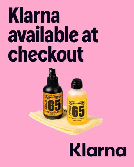 Two bottles of Dunlop 65 on a white surface with a pink background and text about Klarna payment option.